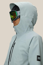 A woman wearing the 686 Women's Hydraª Thermagraph¨ Jacket in white along with goggles.
