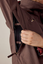 A person opens the zippered underarm vent of the 686 Women's SMARTY® 3-In-1 Spellbound Jacket, exposing black mesh lining inside.