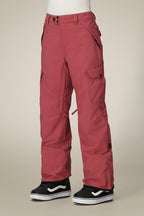 A person wearing 686 Women's Aura™ Insulated Cargo Pant in rose red and black-and-white Vans sneakers stands against a plain beige background, with only their lower body visible.