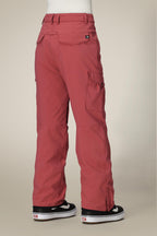A person is shown from the back wearing 686 Women's Aura™ Insulated Cargo Pant in dusty rose with multiple pockets, paired with black and white Vans sneakers, against a neutral background.