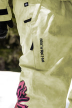 A person wearing a white snow suit paired with 686 Womens Sublime Shell Pant by 686.