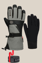 The 686 Men's GORE-TEX SMARTY® 3-In-1 Gauntlet Glove by 686 features a grey and black insulated men’s glove with buckles, wrist strap, poly and PU materials, plus an extra simple black glove and branded black-and-red adjustable strap.