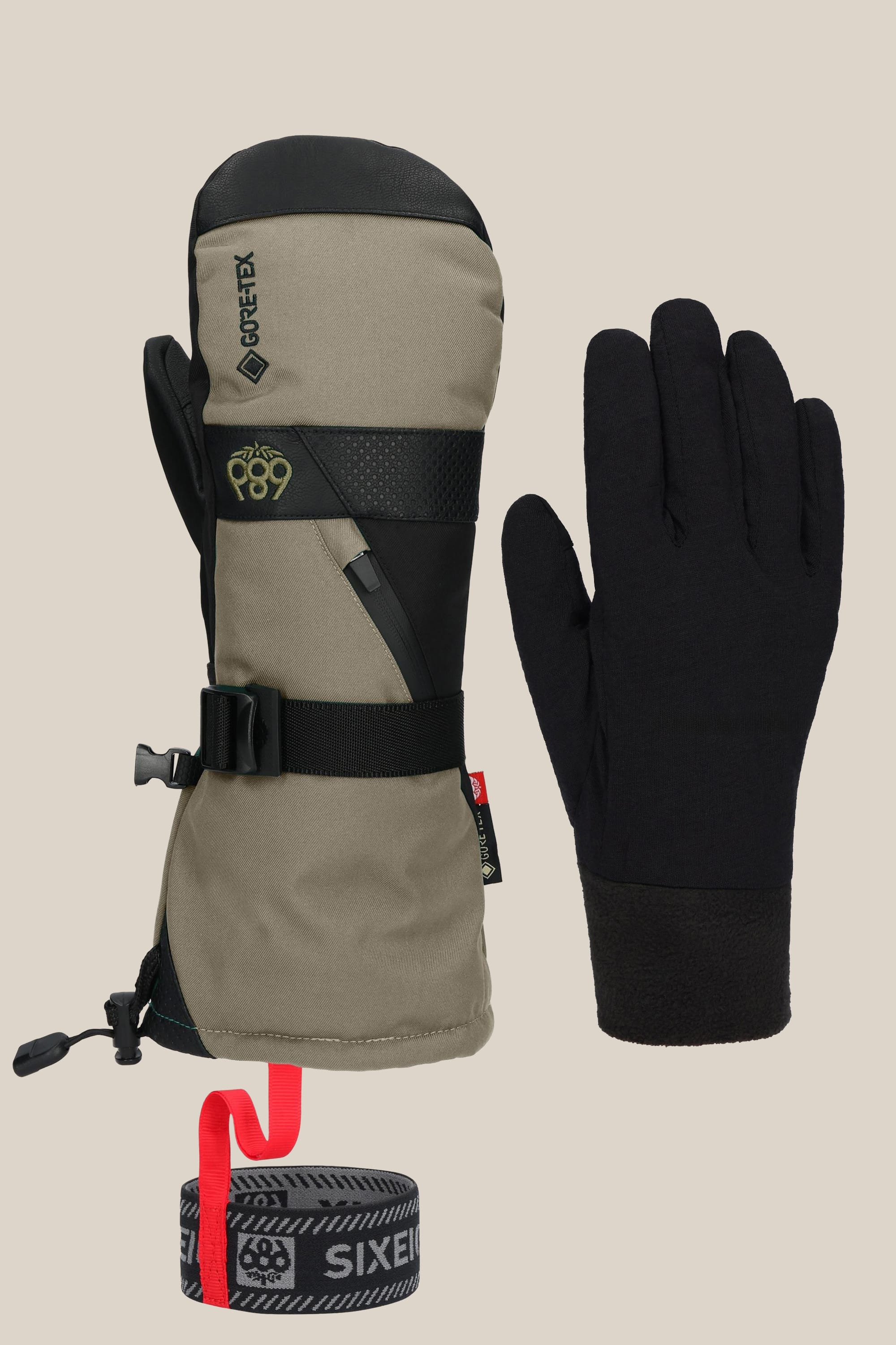 The 686 Men's GORE-TEX SMARTY® 3-In-1 Gauntlet Mitt in khaki and black, featuring a clip, strap, black liner glove, and rolled gray-red wrist leash, is shown on a neutral background. Brand: 686.