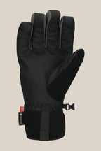 The 686 Men's GORE-TEX Linear™ Under Cuff Glove by 686 is shown palm-up on a beige background, with black insulation, a Velcro wrist strap, and a GORE-TEX tag on the side.