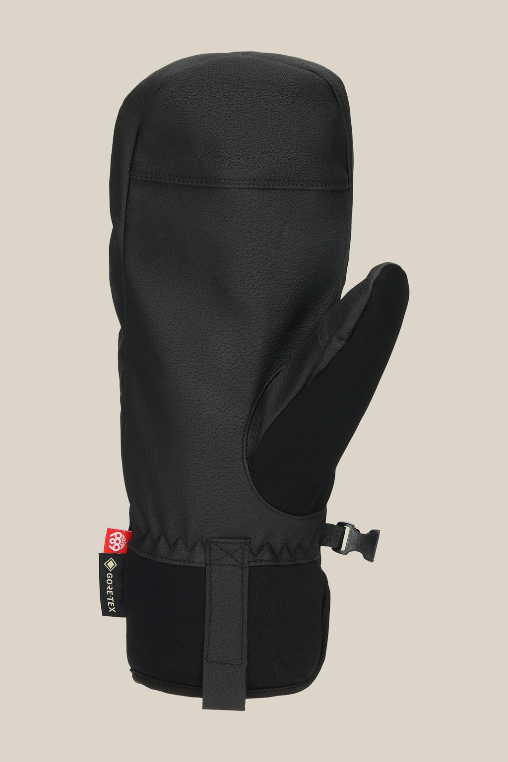 The 686 Men's GORE-TEX Linear™ Under Cuff Mitt, in black PU with a textured finish, features an adjustable wrist strap and a small red and white side tag, shown against a plain beige background.