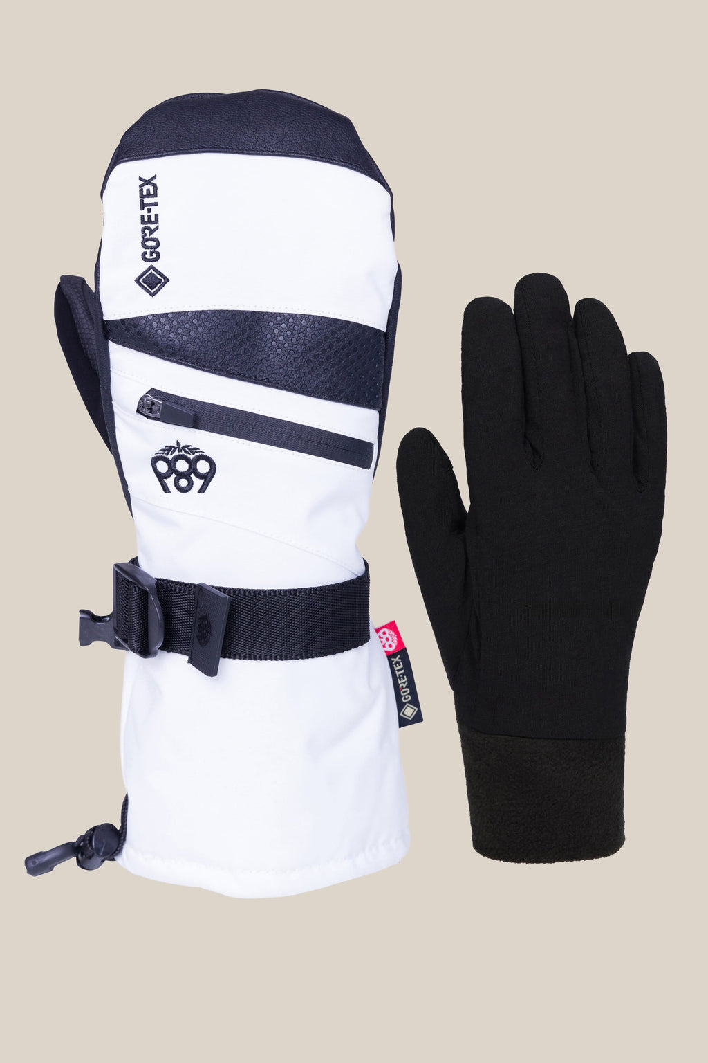 The image shows a 686 Women's GORE-TEX SMARTY® 3-In-1 Gauntlet Mitt in white, black, and grey with a Gore-Tex label, zipper, and wrist strap next to a plain black glove, both set against a simple background. Brand: 686.
