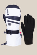 The image shows a 686 Women's GORE-TEX SMARTY® 3-In-1 Gauntlet Mitt in white, black, and grey with a Gore-Tex label, zipper, and wrist strap next to a plain black glove, both set against a simple background. Brand: 686.